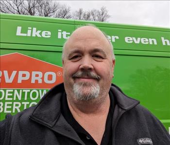 SERVPRO employee in front of green background