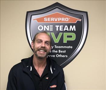 Male crew member in front of SERVPRO logo
