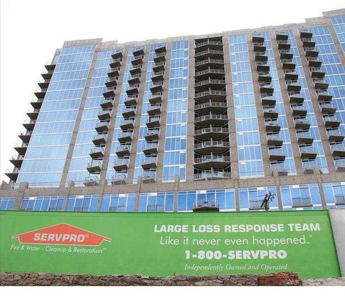 SERVPRO trailer sitting in front of a high-rise building